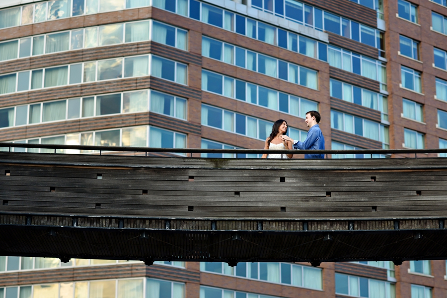 A woman guides her man accross a bridge in battery park.